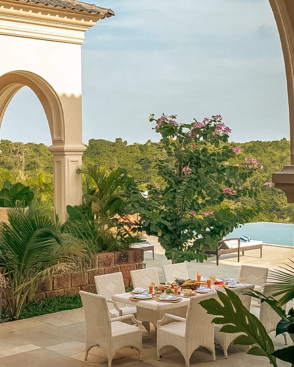 Garden terrace dining beneath archways