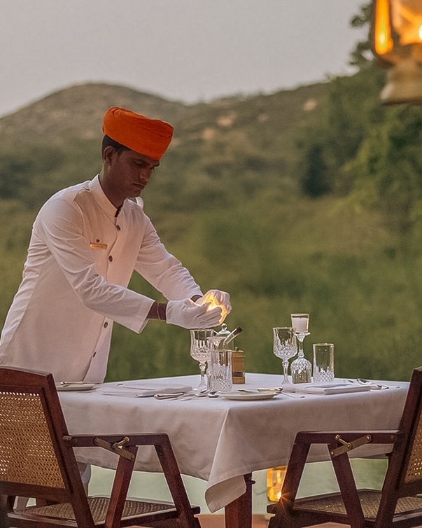 Candlelit private table set in the hills at dusk